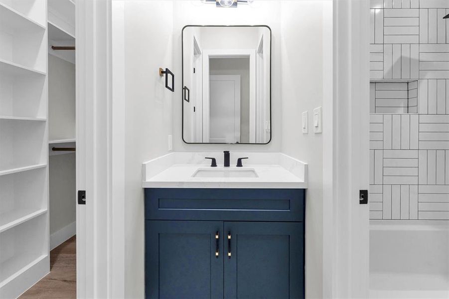 Private vanity with sink off third bedroom with access to jack-and-Jill bathtub/shower