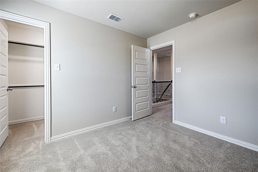 Bedroom 3 upstairs with plush carpet and walk-in closet