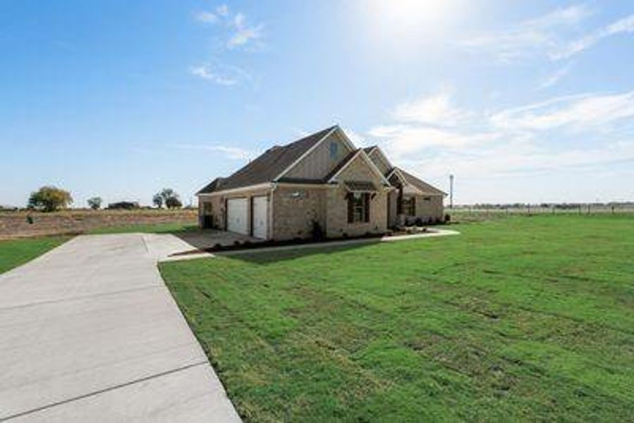 View of property exterior with a lawn