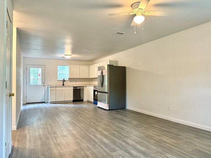 Kitchen featuring ceiling fan, dark wood-type flooring, sink, white cabinets, and appliances with stainless steel finishes