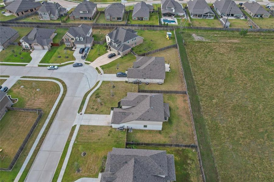 A bird’s-eye perspective of the expansive backyard, highlighting the property’s generous size and open space.