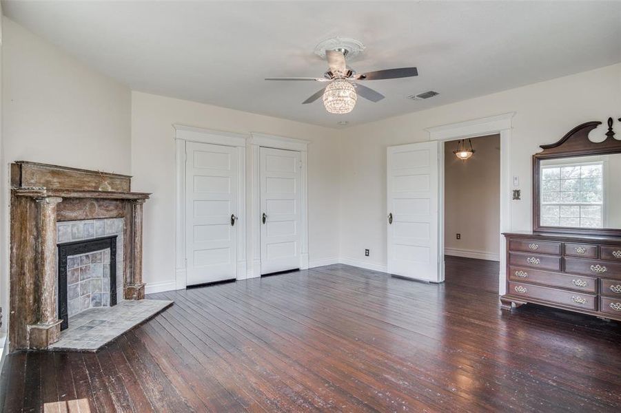 Unfurnished living room featuring hardwood / wood-style floors and ceiling fan