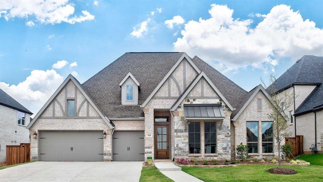 Tudor-style house with a garage and a front lawn