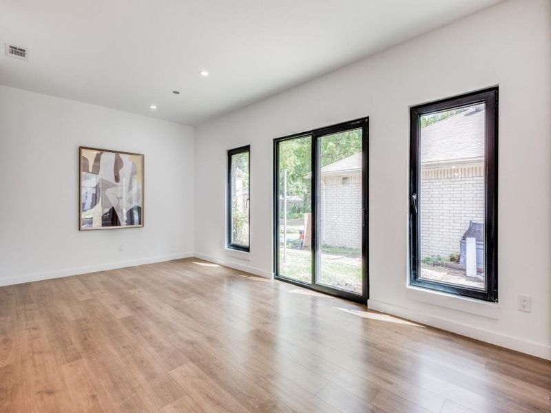 Spare room with light wood-type flooring and plenty of natural light