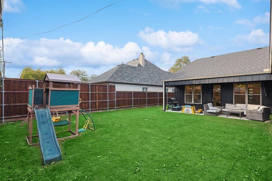 View of yard featuring a playground and an outdoor hangout area