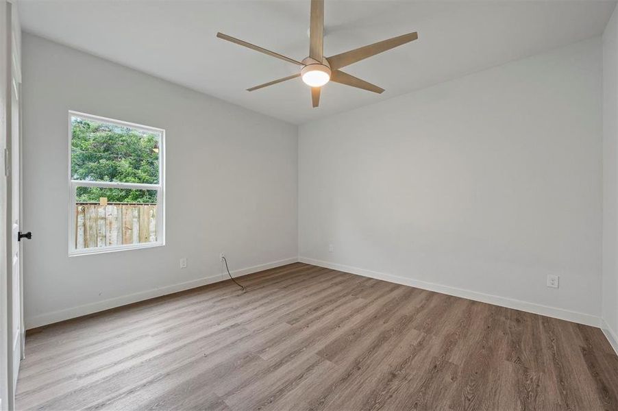 Empty room with light wood-type flooring and ceiling fan