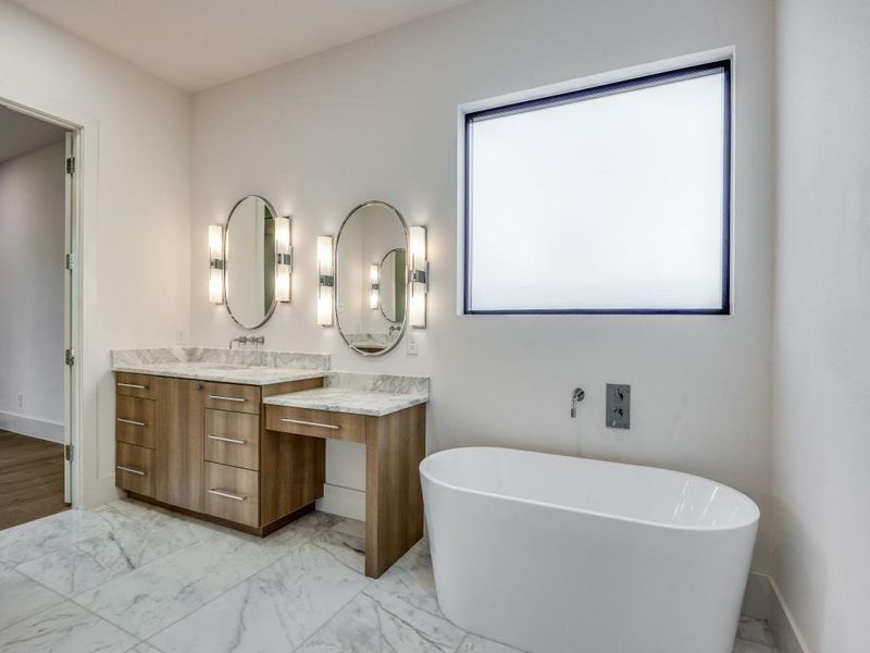 Bathroom with vanity and a bath