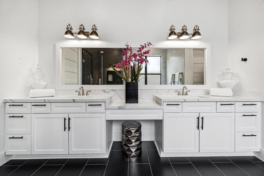 Daily routine excellence! View of the double vanities with a convenient nook, highlighted by timeless quartz countertops