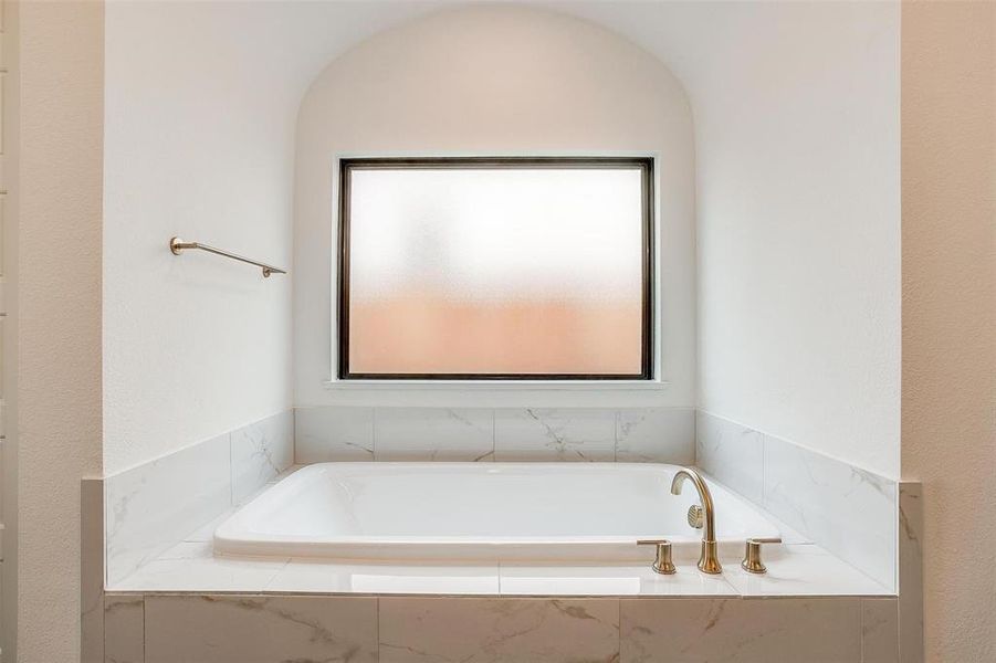 Bathroom with a relaxing tiled bath