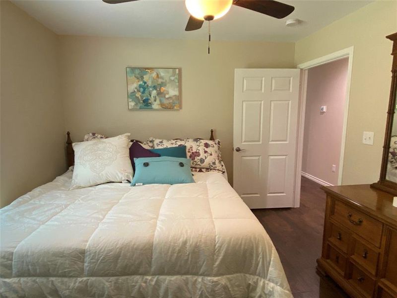 Bedroom 2 with ceiling fan and dark wood-type flooring