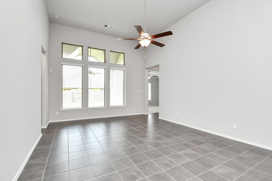 The family room features expansive ceilings and windows that fill the space with natural light creating a bright inviting atmosphere