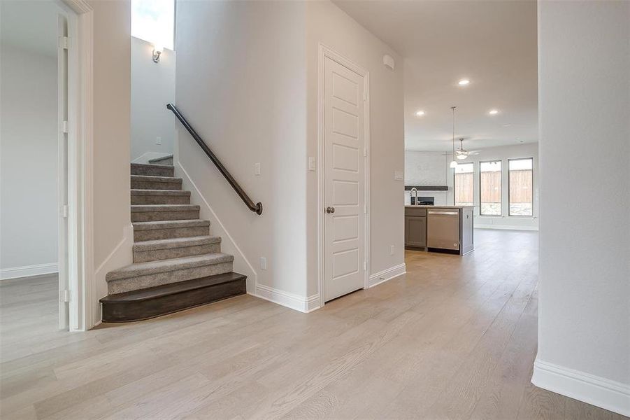 Staircase featuring light hardwood / wood-style floors, sink, and ceiling fan