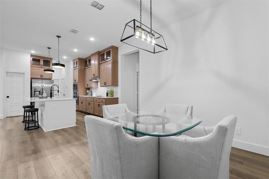 Dining room with sink and light hardwood / wood-style flooring