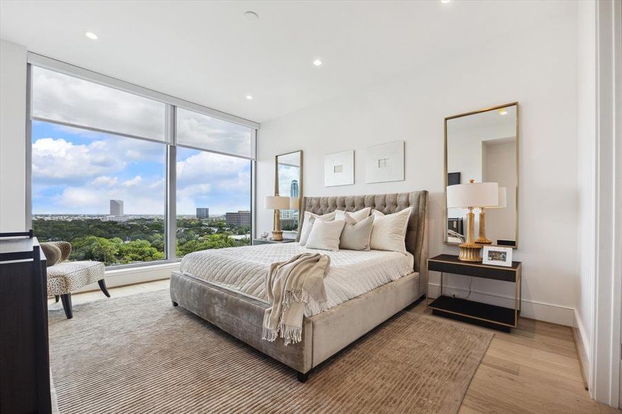 Staged with a king-sized bed and side tables, it is easy to imagine waking up in the primary bedroom with this beautiful view in the morning.