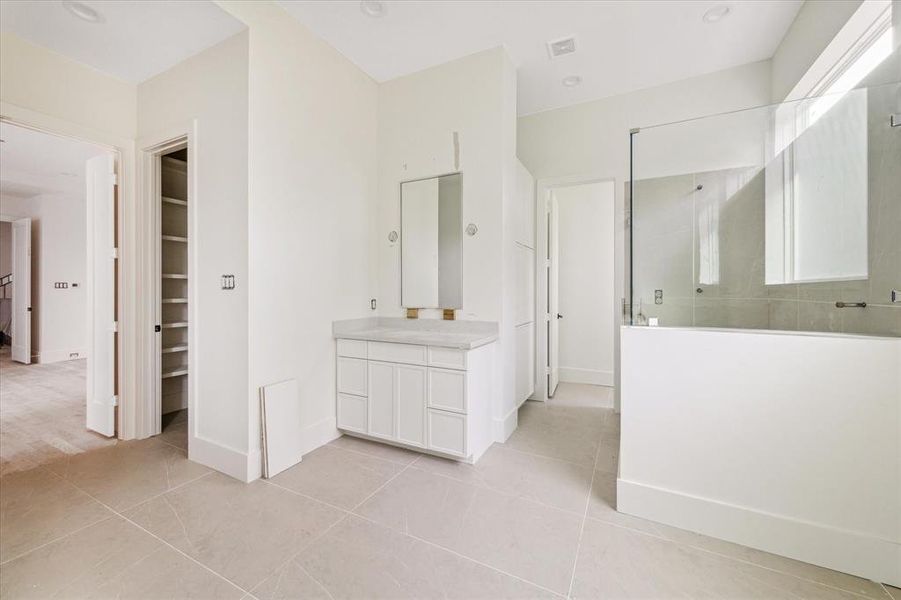 You'll find a seamless glass shower and separate soaking standalone tub.