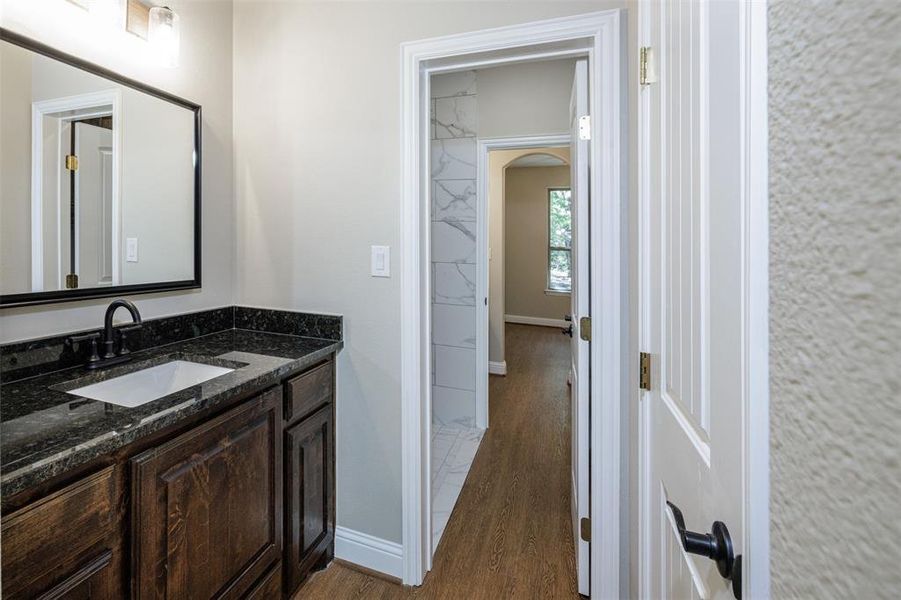 Bathroom featuring wood-type flooring and vanity