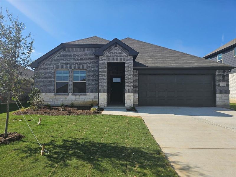 View of front of house with a front lawn and a garage