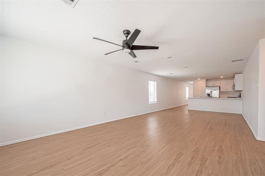 The large open concept room seamlessly connects the breakfast bar to the dining area, creating a perfect flow for both casual meals and entertaining.