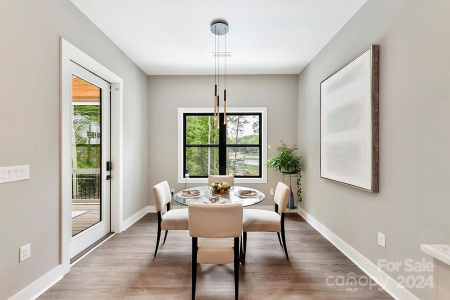 Breakfast Area with black framed windows for elegance & glamour, custom lighting, covered patio access & LVP floors!