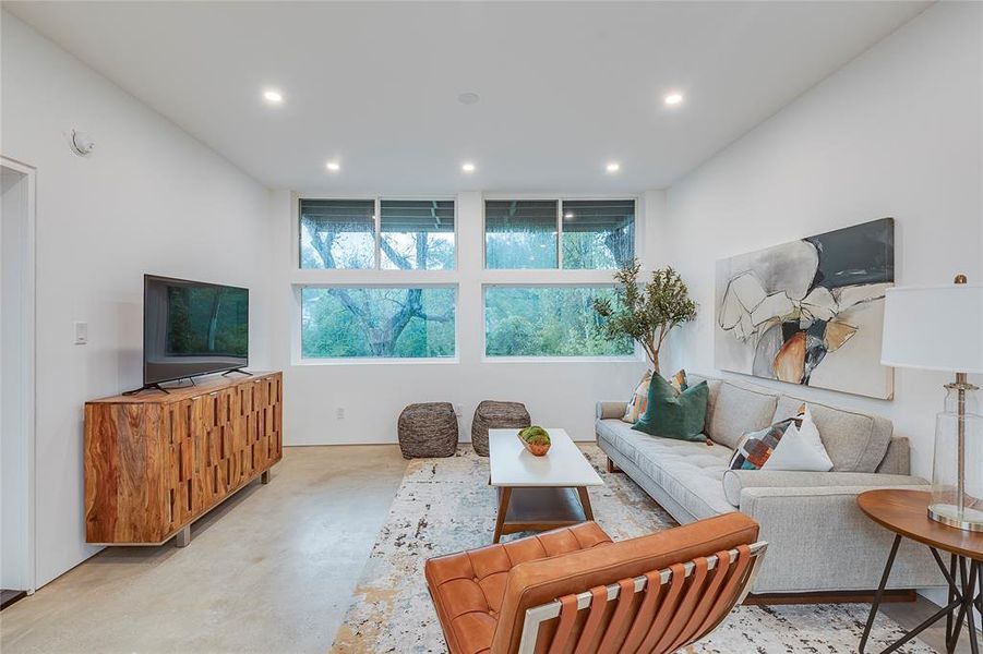 Wall of windows with amazing creek views and door to the deck from living room.