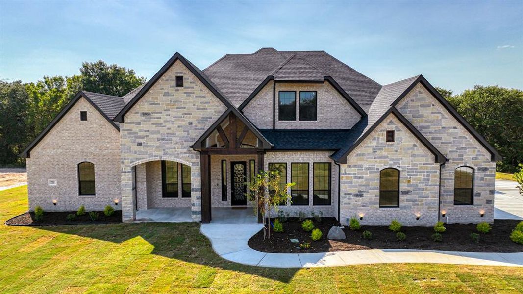 View of front of home with a front lawn and a patio