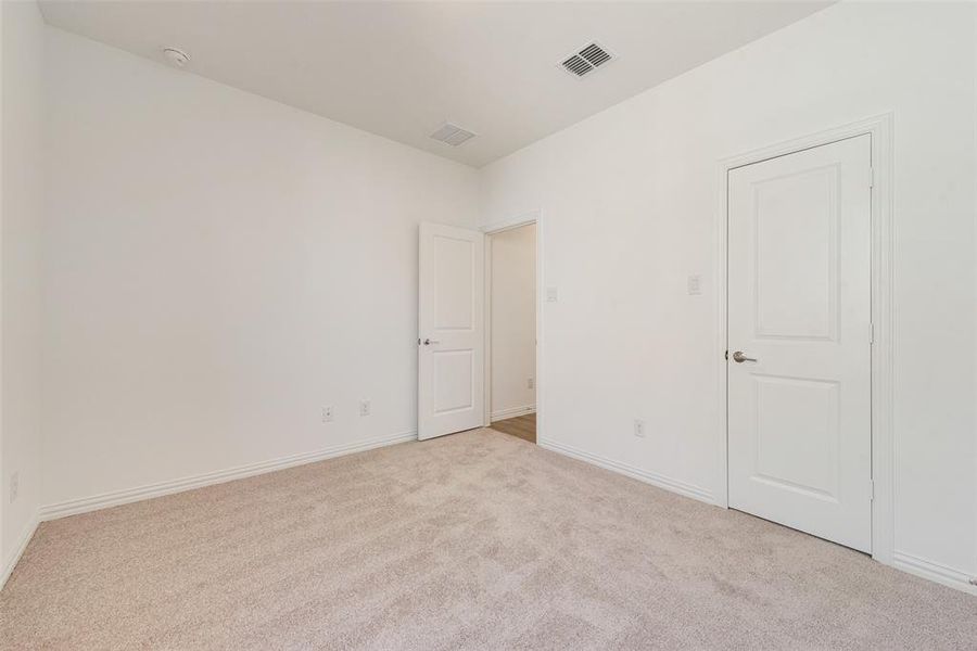 Unfurnished room featuring light colored carpet