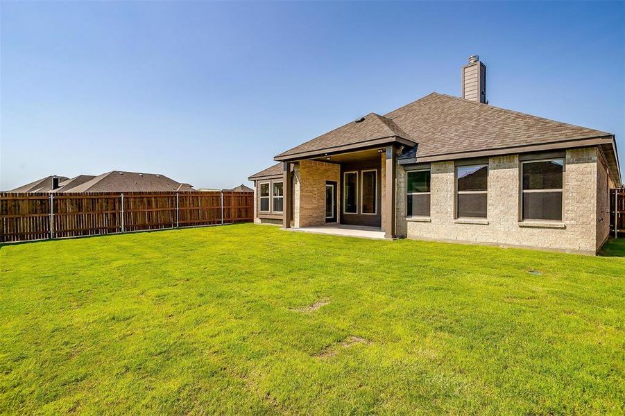 Back of house featuring a yard and a patio area