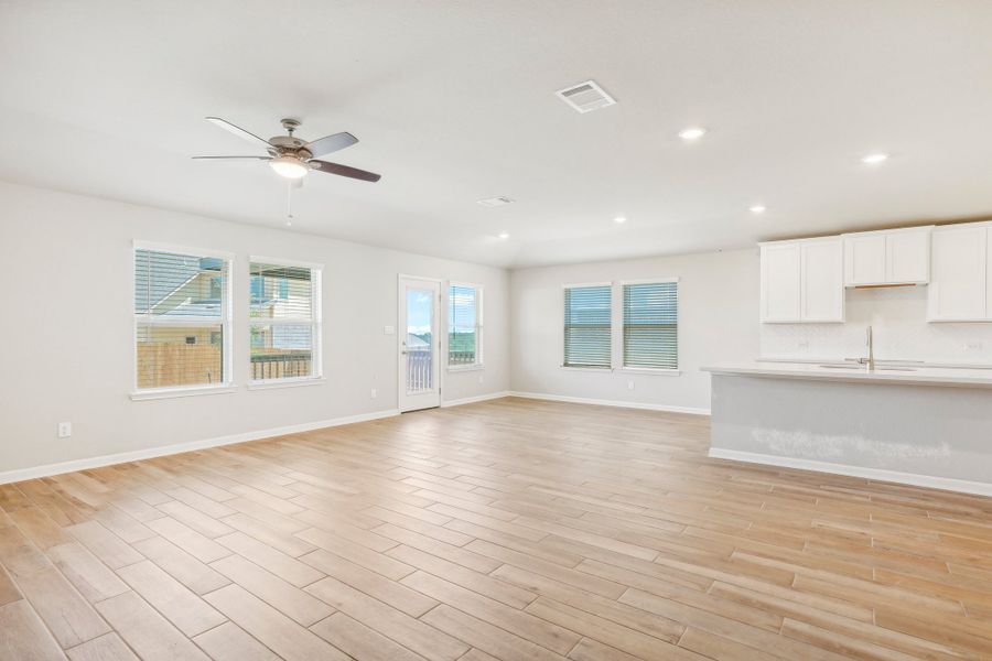 Living room and dining room in the Fitzhugh floorplan at a Meritage homes community.