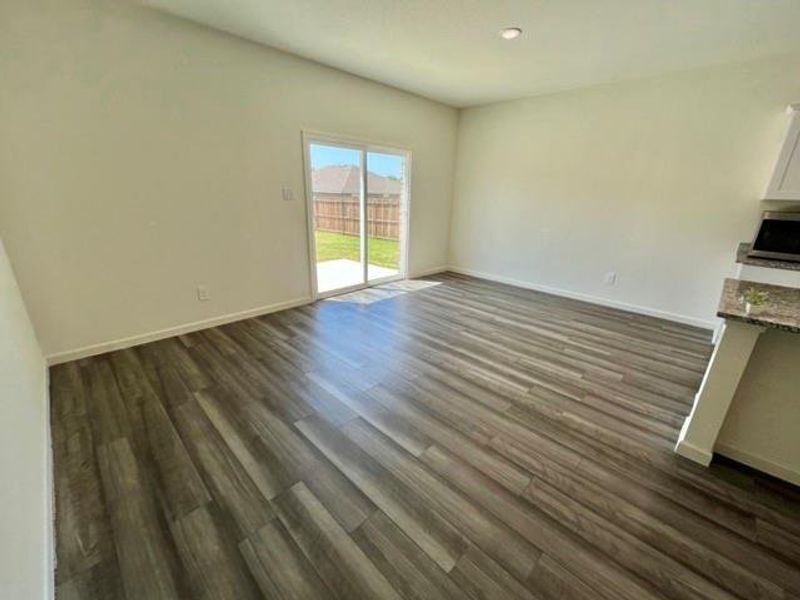 Unfurnished living room with dark hardwood / wood-style floors