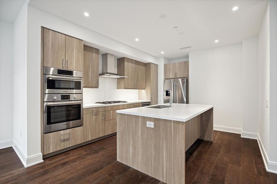 Another view of the Kitchen/breakfast bar, residences come equipped with Bosch appliances and gas cooktops.