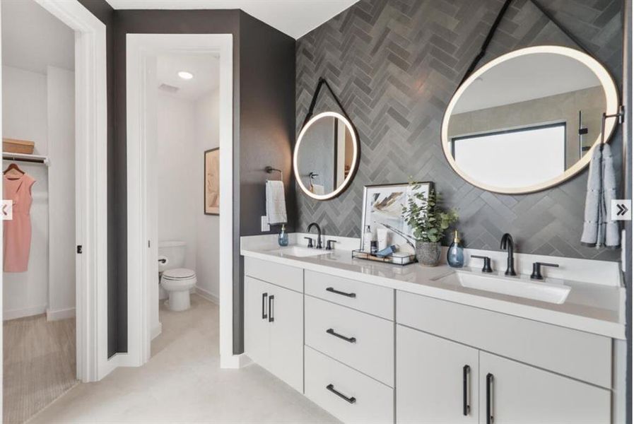 You'll never ant to leave your main bathroom. Double vanities with plenty of storage space.