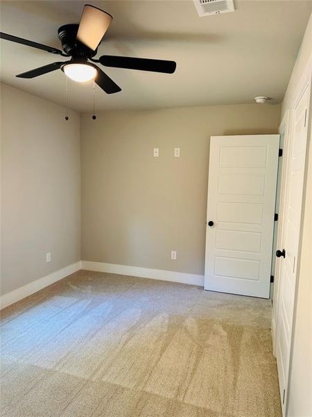 Bedroom featuring ceiling fan and light carpet