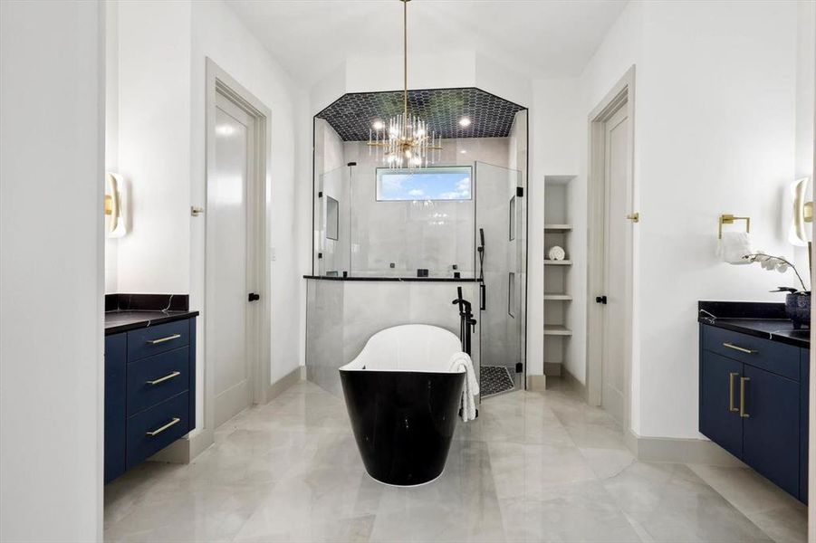 Bathroom with a chandelier, tile patterned flooring, vanity, and an enclosed shower