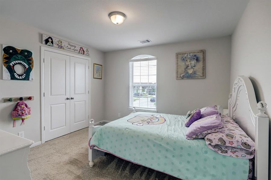 Beautiful second bedroom with natural light coming from window.