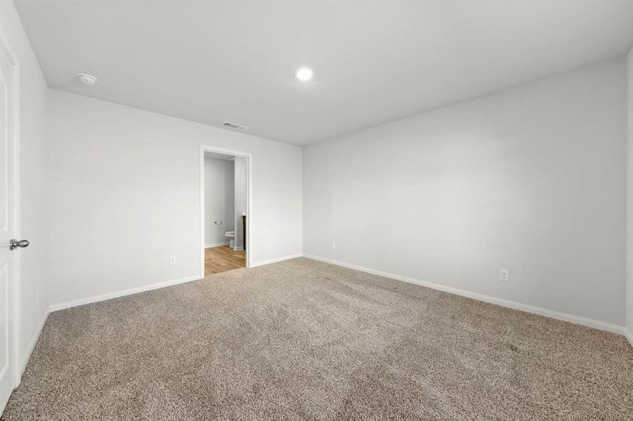 Unfurnished bedroom featuring light carpet