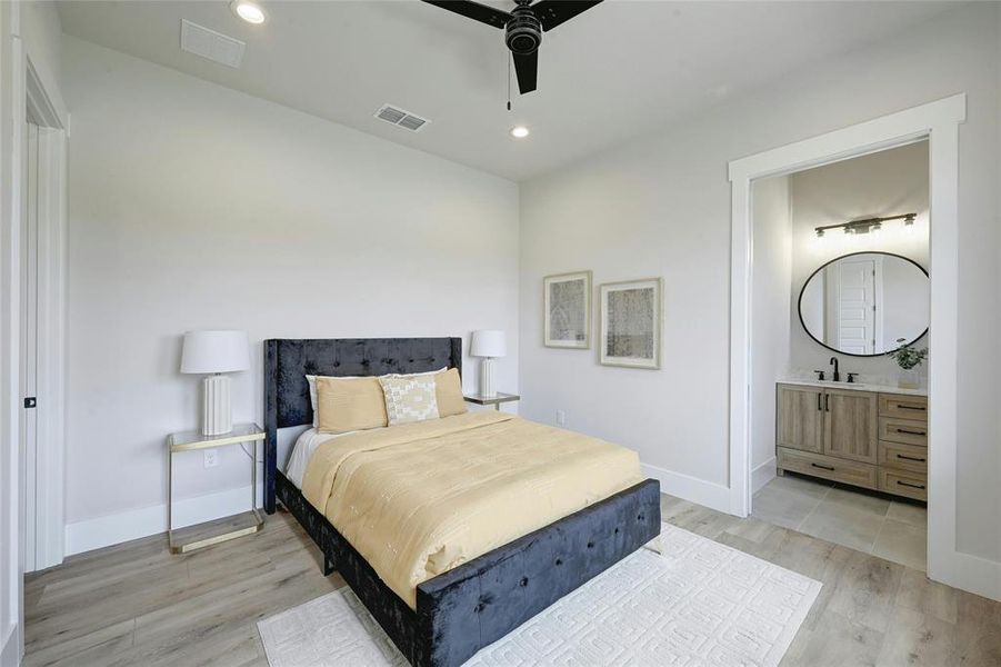 One of the four bedrooms featuring high ceilings, walk in closet, ceiling fan, and on-suite bath.