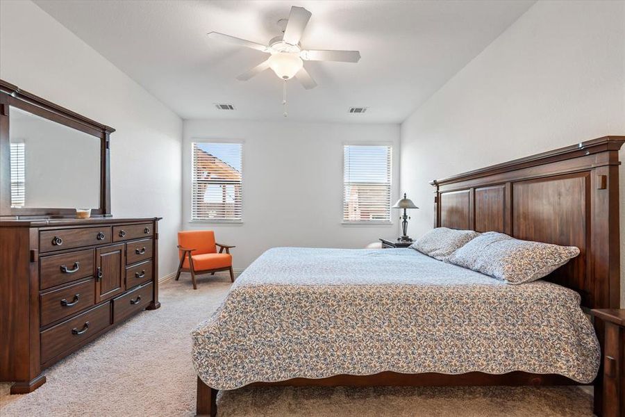 Carpeted bedroom with ceiling fan