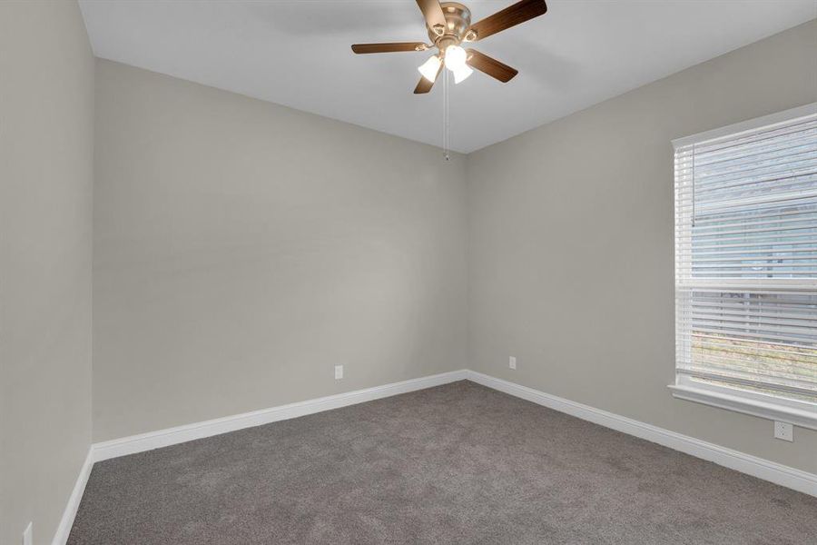 Bedroom featuring ceiling fan and carpet flooring