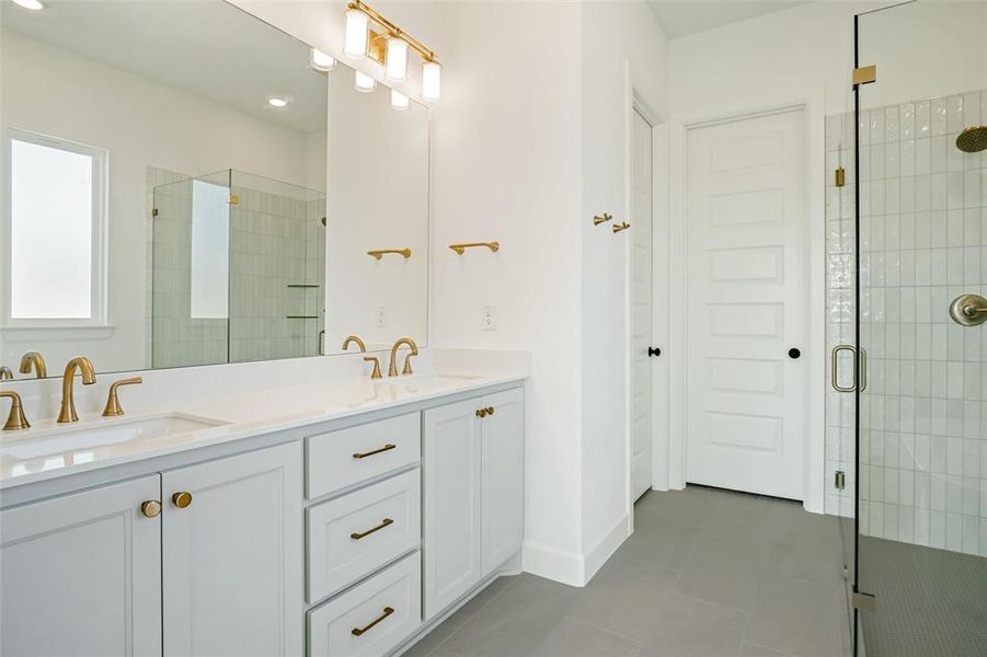 Bathroom with vanity and a shower with shower door