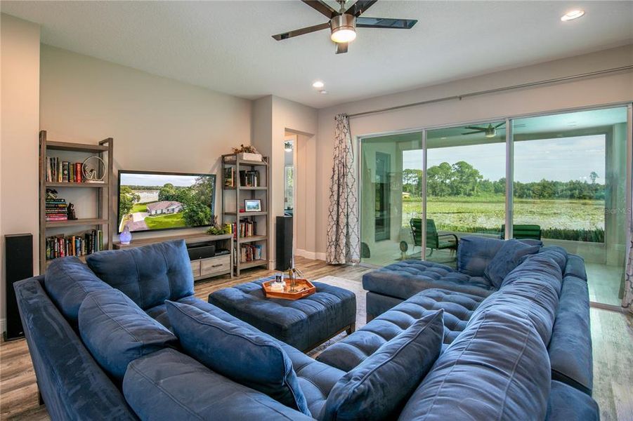 Main living area towards the huge pocket window sliders, screened lanai, and lake.