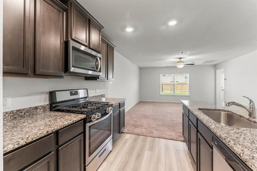 The convenient floor plan makes it easy for Mom to manage the family while preparing meals!  Kitchen is open to Breakfast Room and Dining Room so it's easy to interact with family or guests while putting last-minute finishes on dinner or dessert.