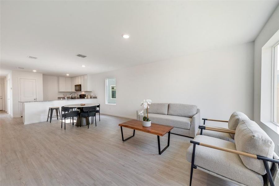 Living room with light hardwood / wood-style flooring