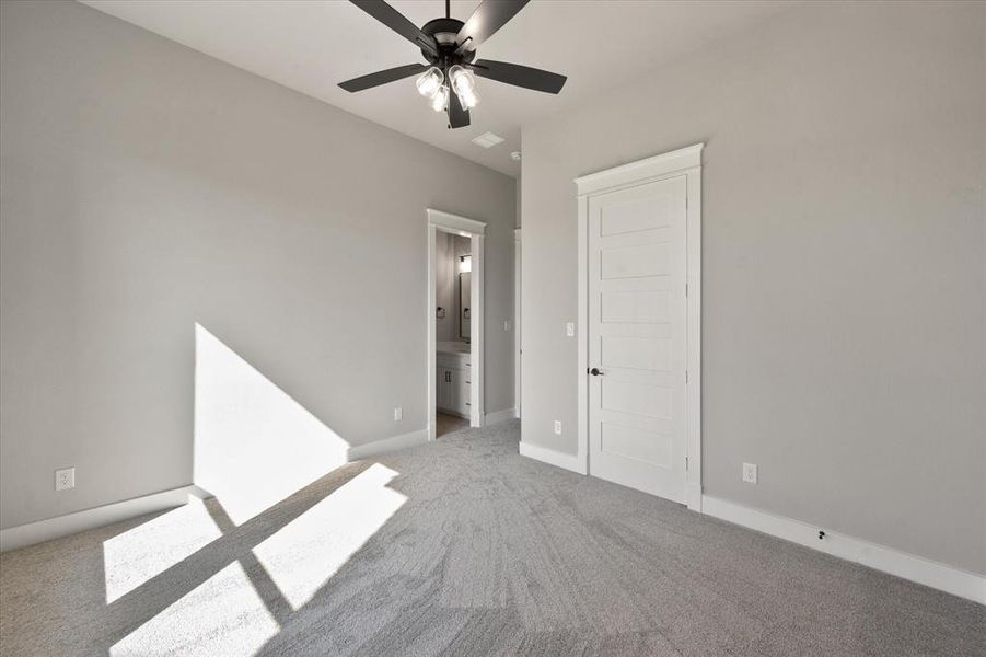 Empty room with ceiling fan and carpet