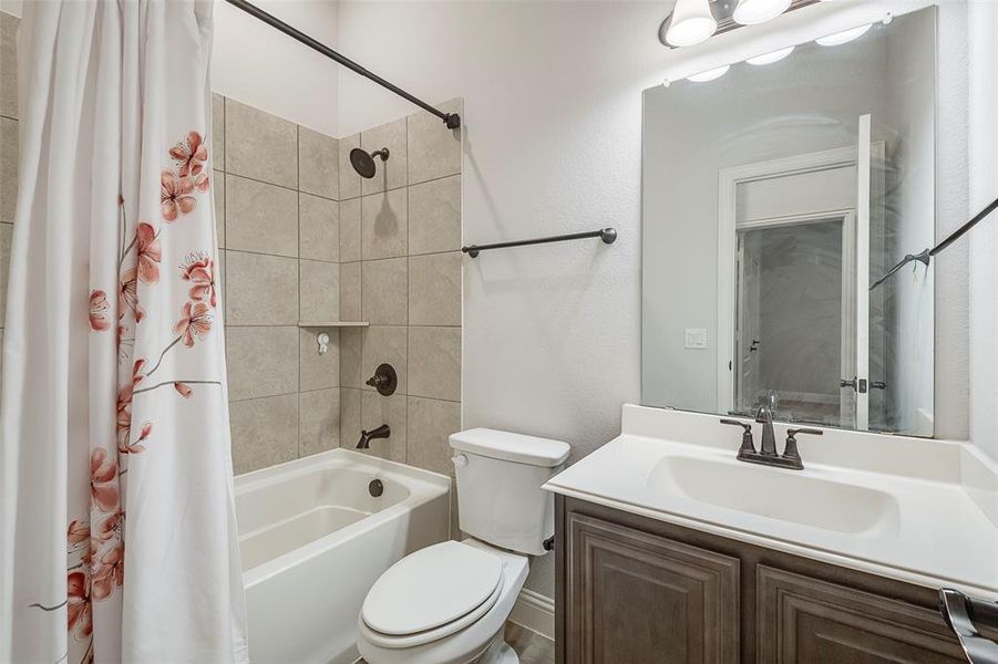 Full bathroom with vanity, toilet, and shower / bath combo