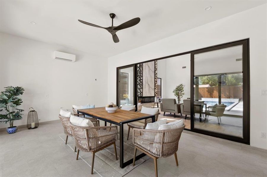 Dining area featuring ceiling fan and an AC wall unit