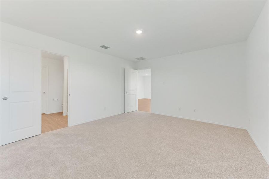 Empty room with light colored carpet