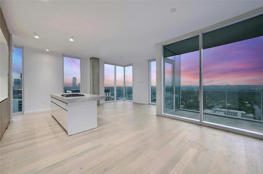 Floor-to-ceiling windows frame breathtaking nighttime views of the city, allowing you to cook and entertain with a stunning backdrop. The open concept design flows effortlessly into the living area, enhancing the space's overall sense of openness and light. *Linden Residence No. 2105 Shown Here