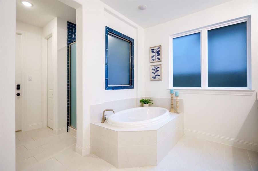 Bathroom featuring plus walk in shower and tile patterned flooring