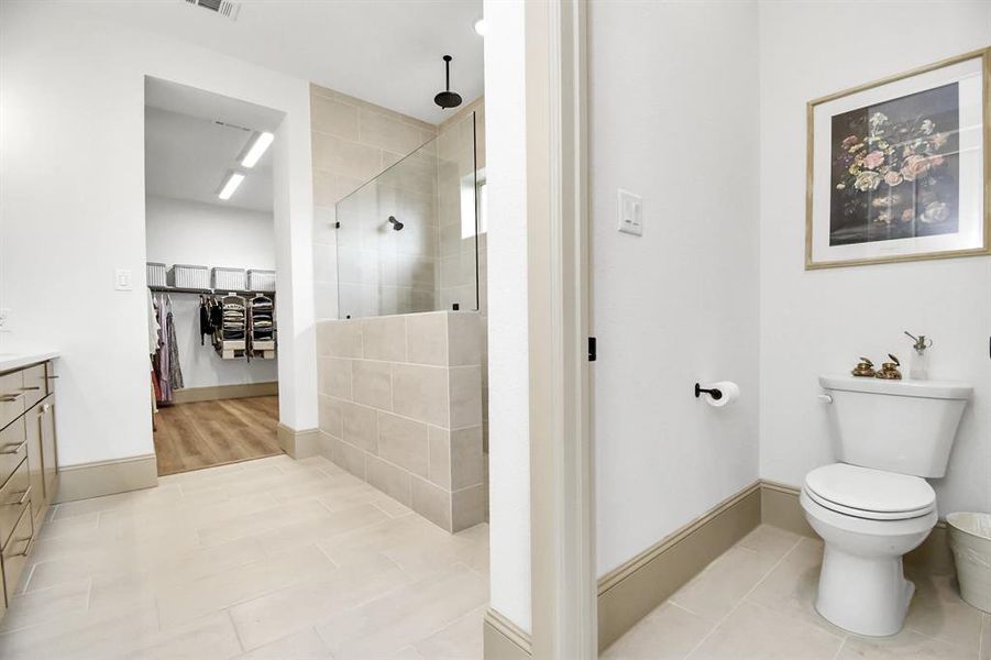 Separate water closet for added privacy within the primary ensuite.