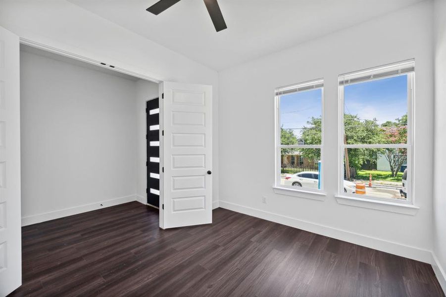 Unfurnished bedroom featuring dark hardwood / wood-style floors and ceiling fan